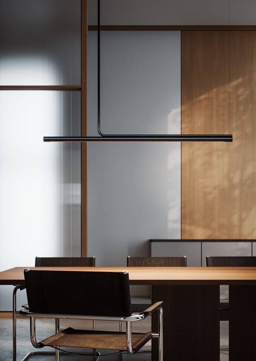 Marset Ambrosia pendant lamp in black on an office desk. 