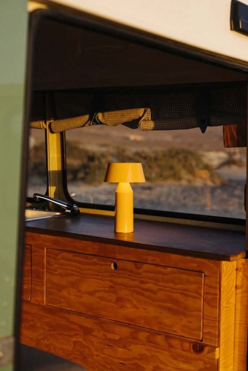 Marset Bicoca portable table lamp in mustard yellow for interiors. 